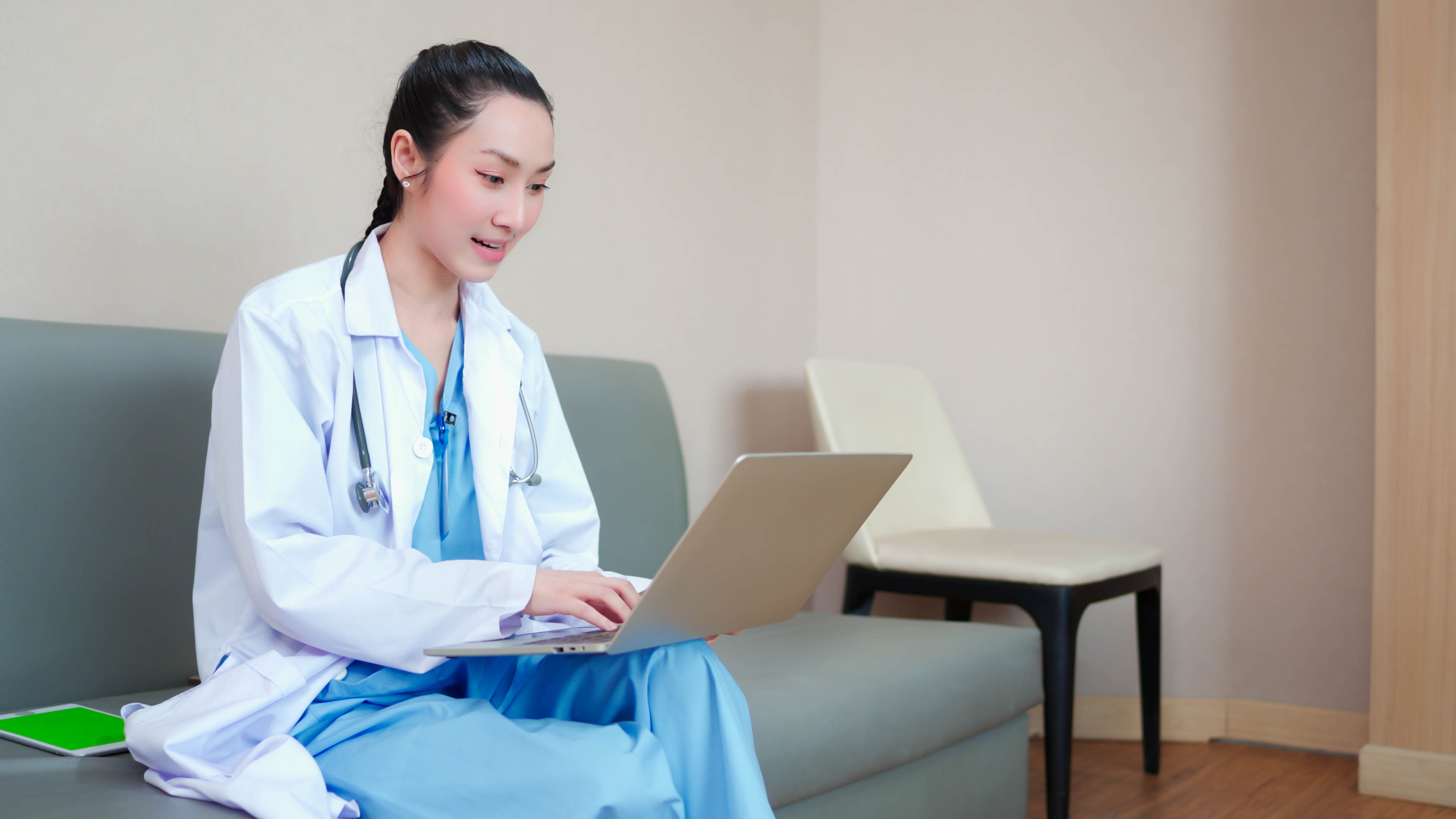 a doctor working on a laptop