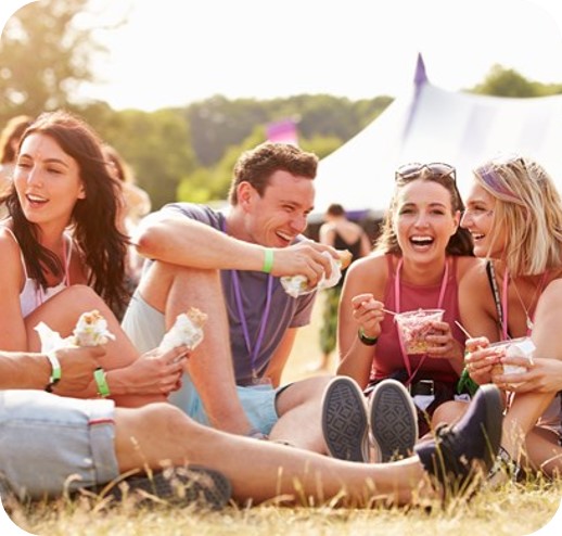 a group of people sitting on the grass