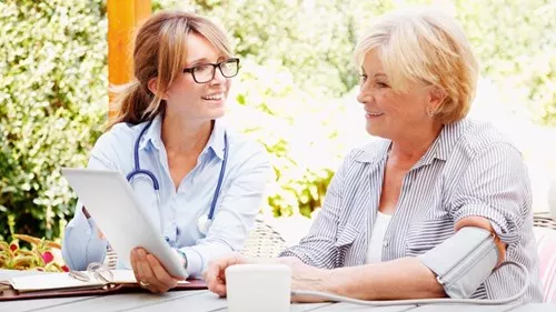 a doctor and a patient looking at tablet