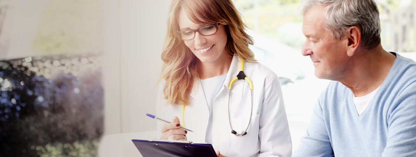 a doctor showing something to a patient on a tablet