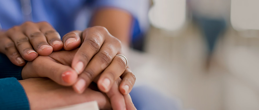 a close-up of hands holding each other