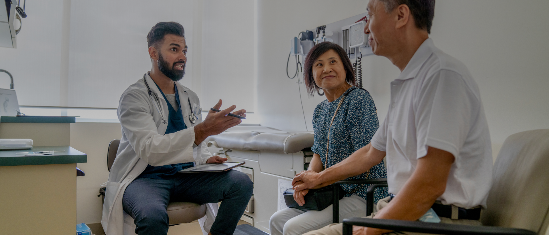 Doctor talking to patient and his wife