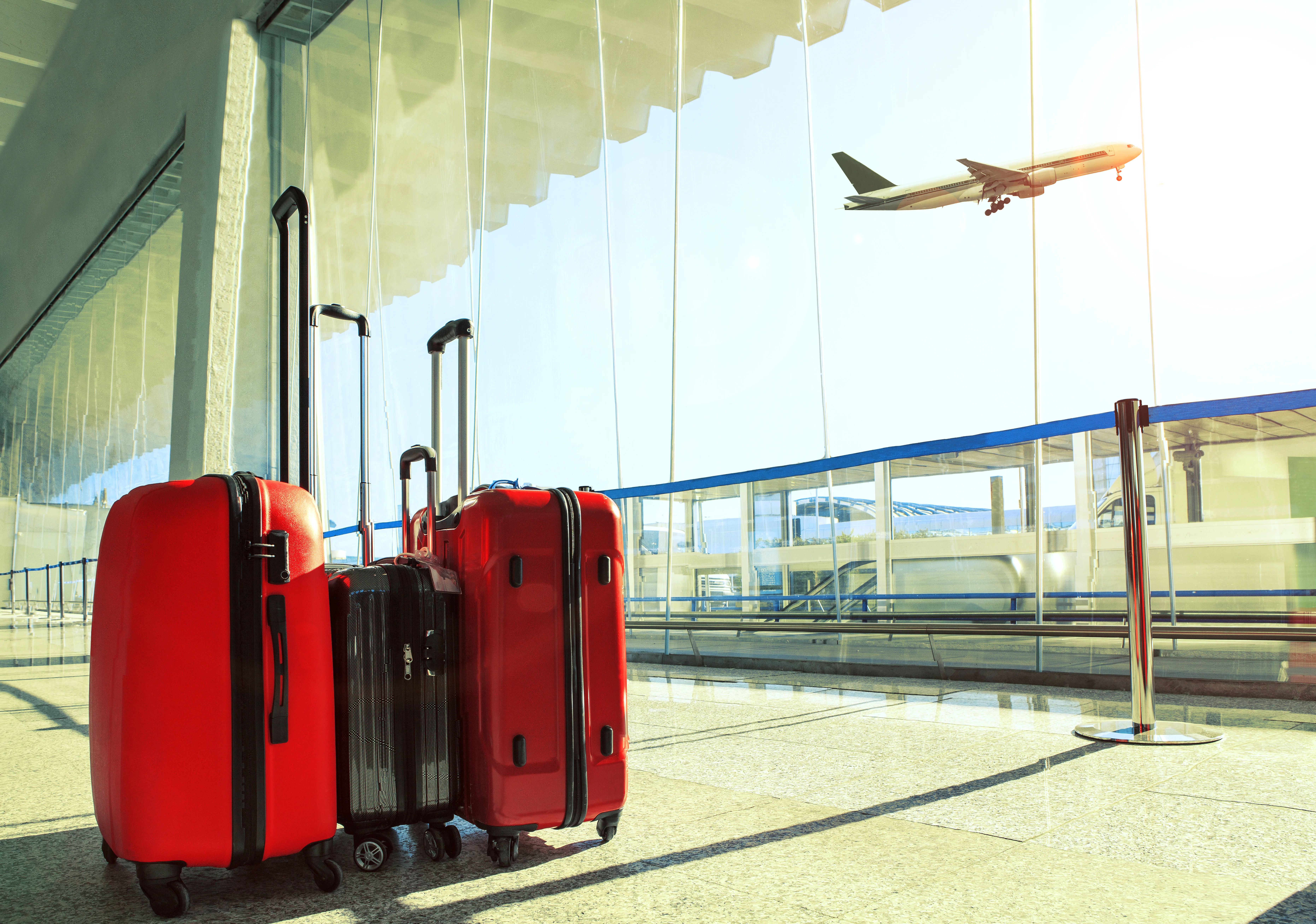 a plane flying over a group of luggage