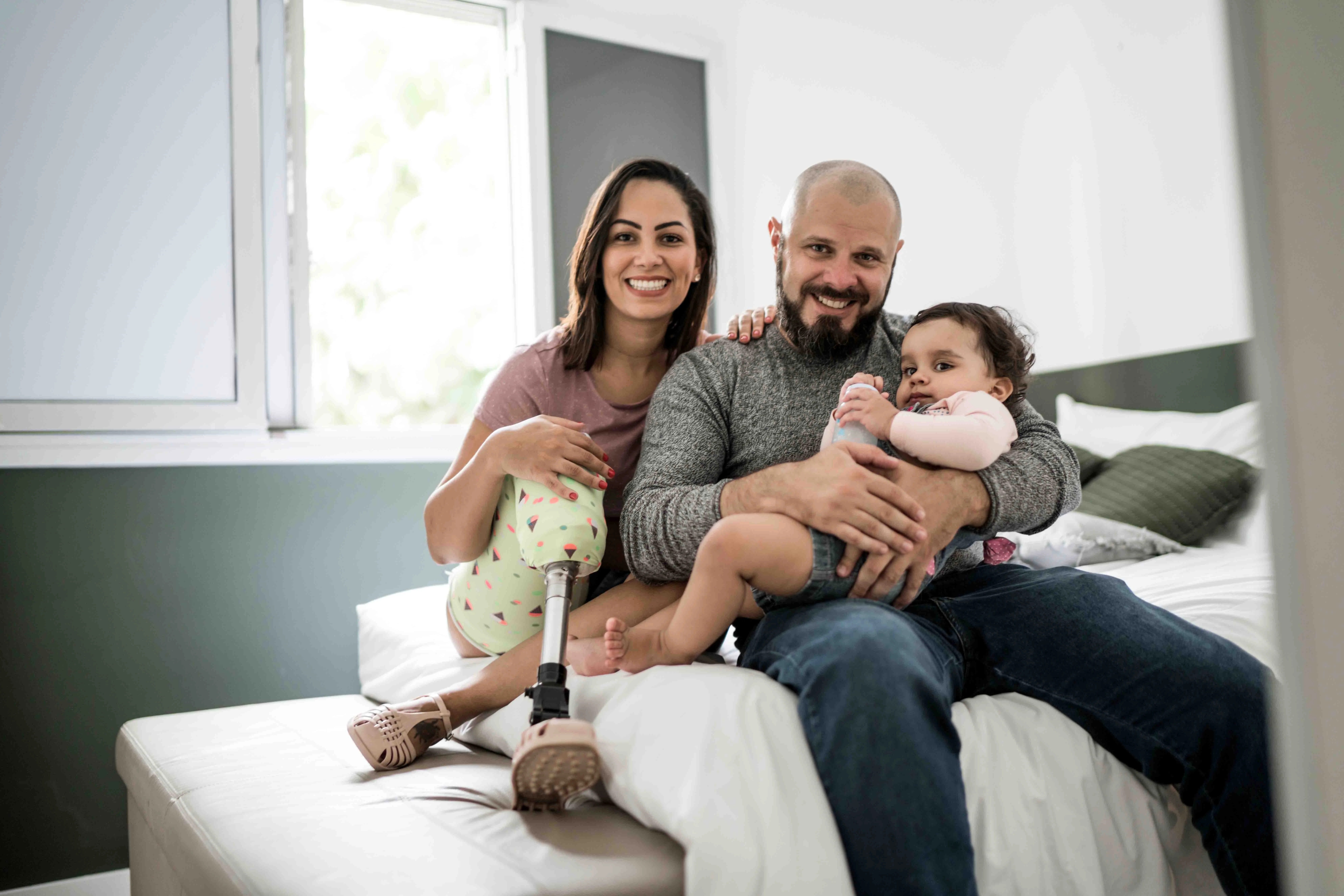 a man and woman holding a baby